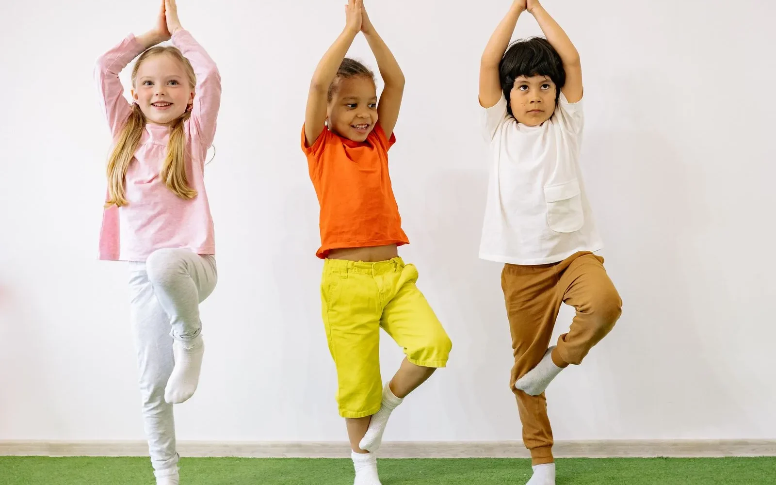 Three children balancing and playing together