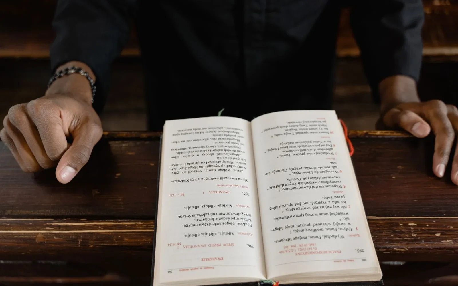 Hands resting open bible service