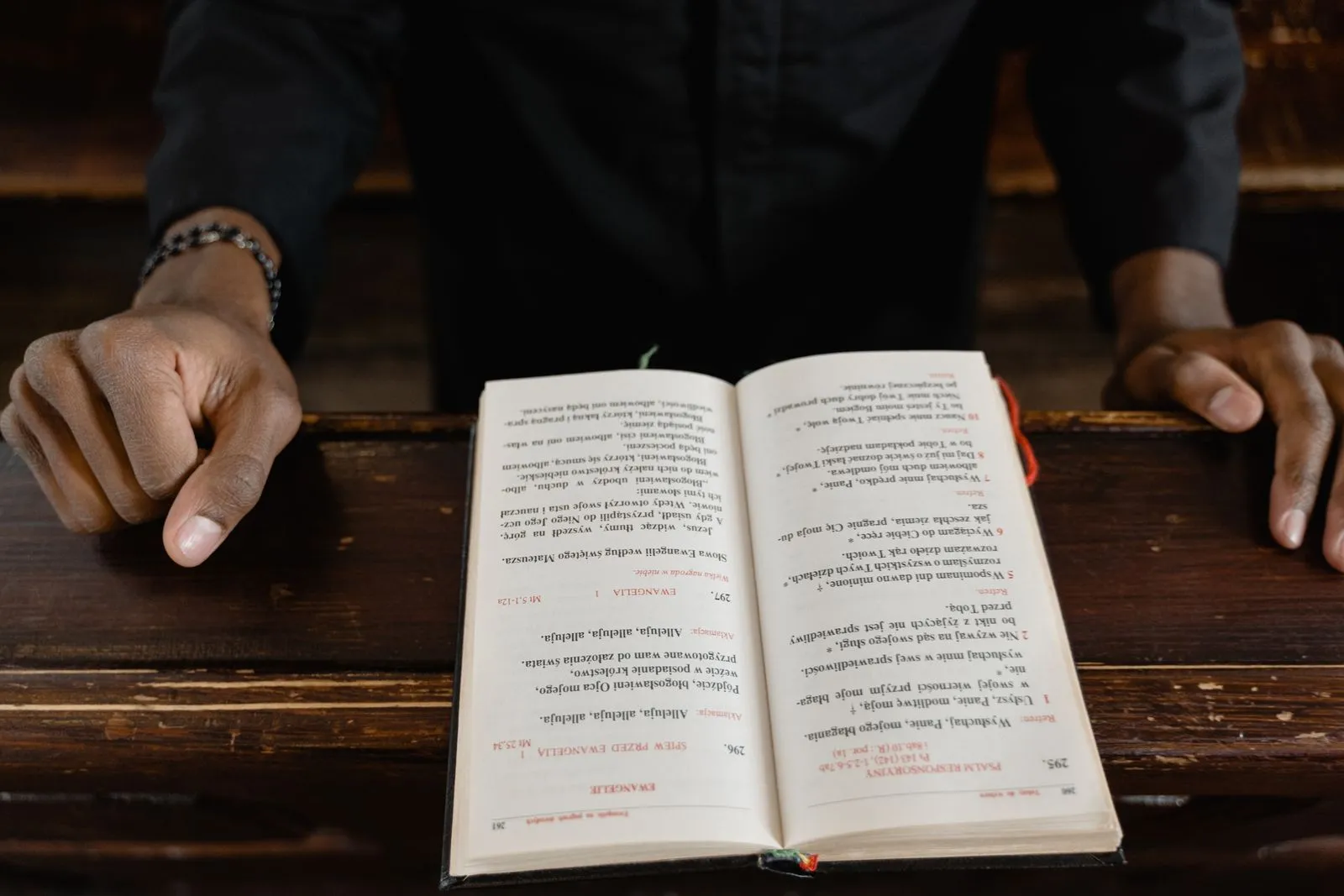 Hands resting open bible service