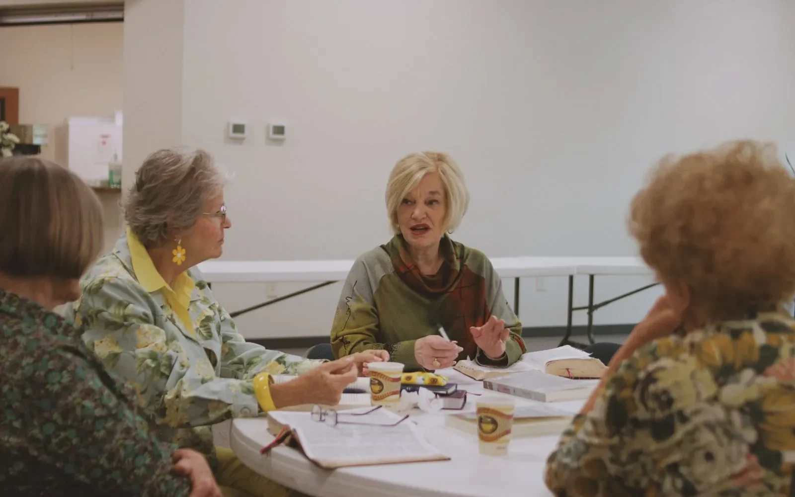 Intergenerational group studying scripture around table