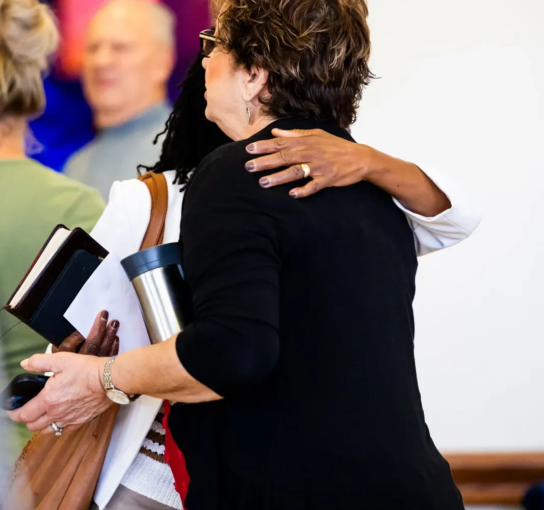 Two people greeting each other warmly