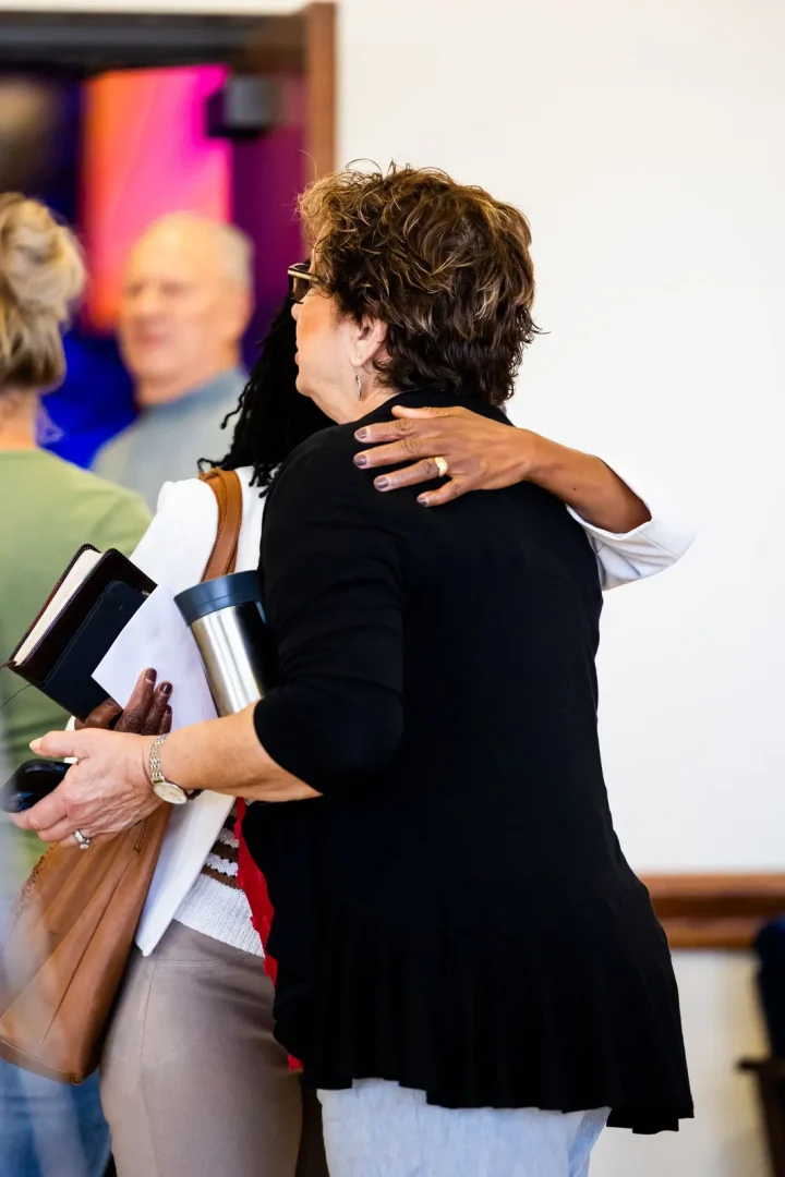Two people greeting each other warmly