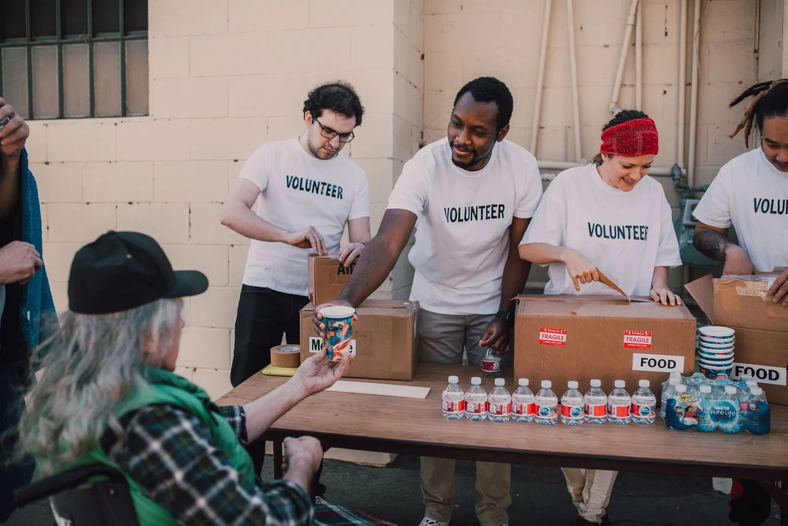 Volunteers handing out food community table