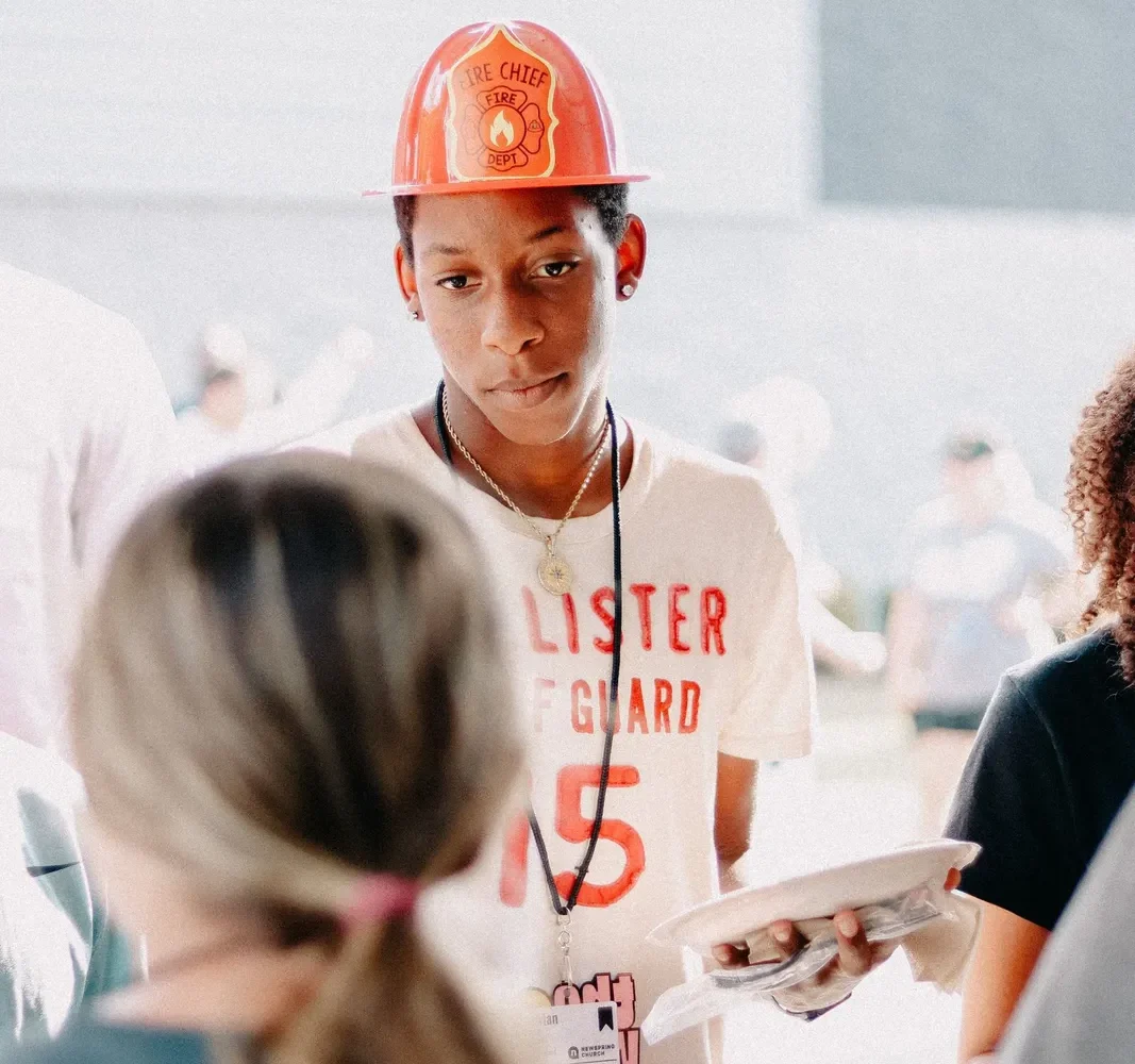 Young volunteer serving church event